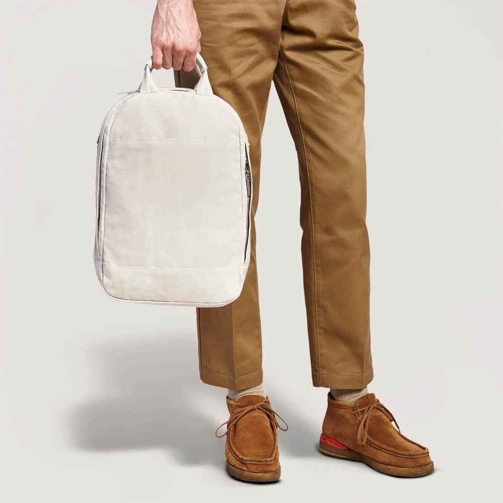 slim backpack held by man