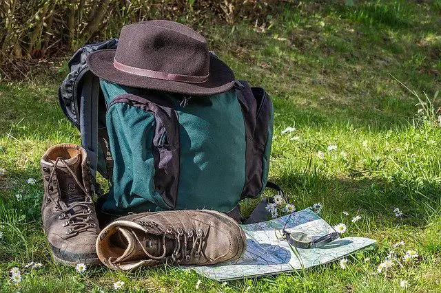 backpack next to hat and hiking boots