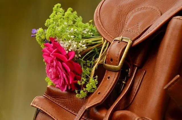 leather backpack with flower in it
